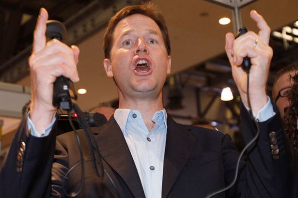 nick clegg cheers after hitting a bullseye while playing archery on a nintendo wii 675568285