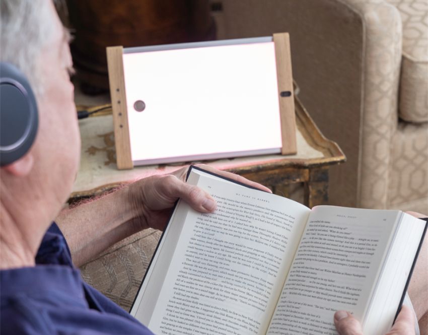 Man in front of light while reading by optoceutics