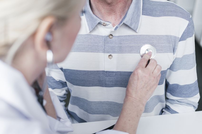 doctor checking patient heart