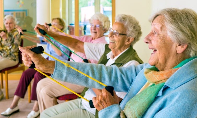 elderly exercising while seated