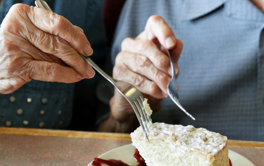 elderly people eating a sweet