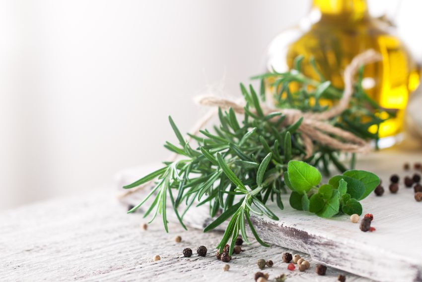 herbs and olive oil on table 