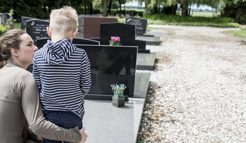 kid in front of gravestone