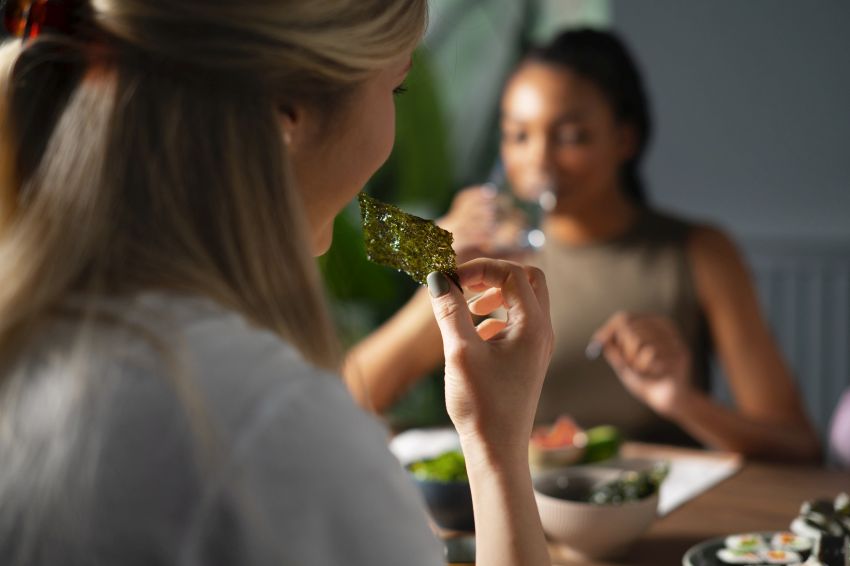 person eating seaweed snacks