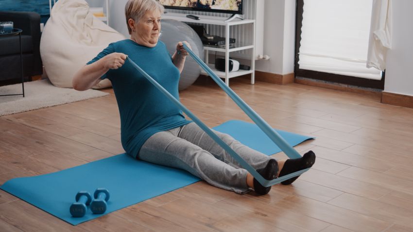 senior lady doing resistance exercise workout
