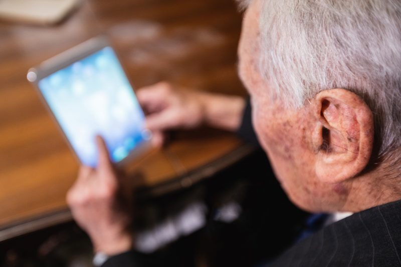 senior man watching a tablet