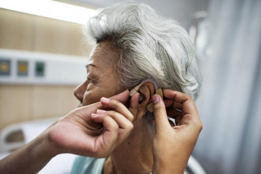 woman getting hearing aid fitted